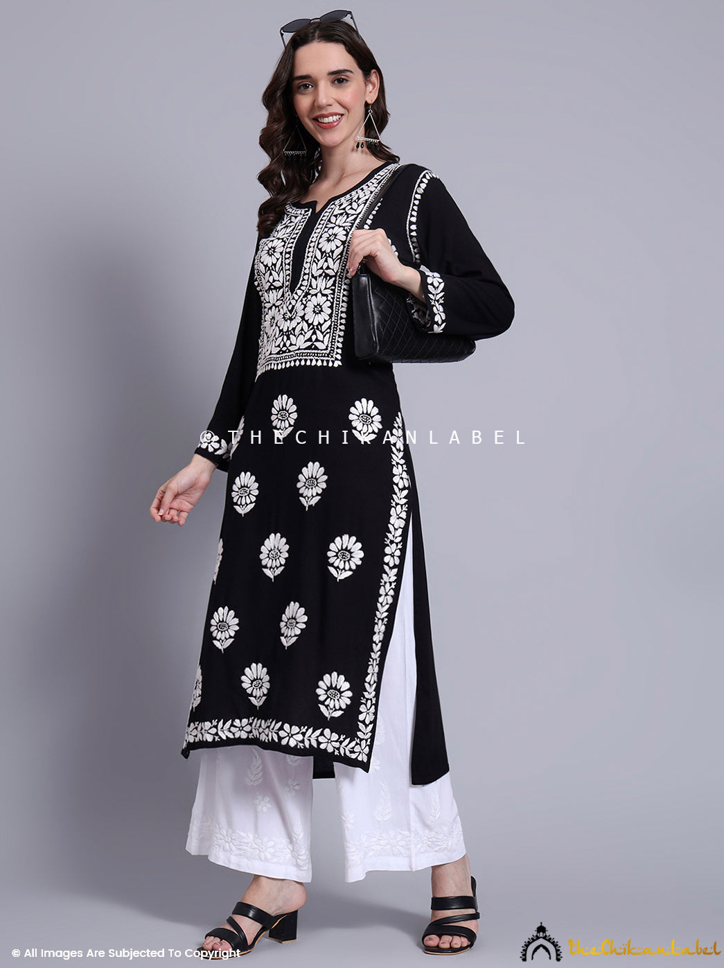 Trendy rayon chikankari kurti with artisan embroidery, styled with statement earrings and ethnic flats.

