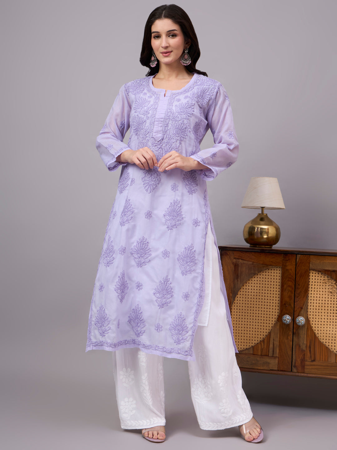 Women's trending kurti featuring handcrafted Lucknow Chikankari embroidery, premium cotton construction, soft inner lining, and elegant straight-fit styling.