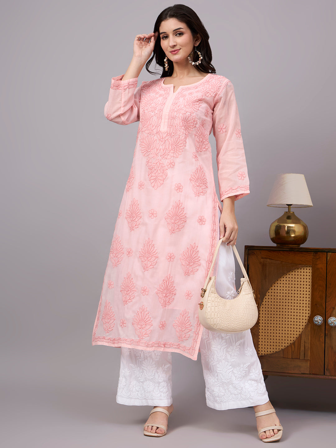 Elegant comfortable regular wear kurti with premium cotton fabric, handcrafted Chikankari embroidery, attached inner, and a straight-cut silhouette for daily fashion.