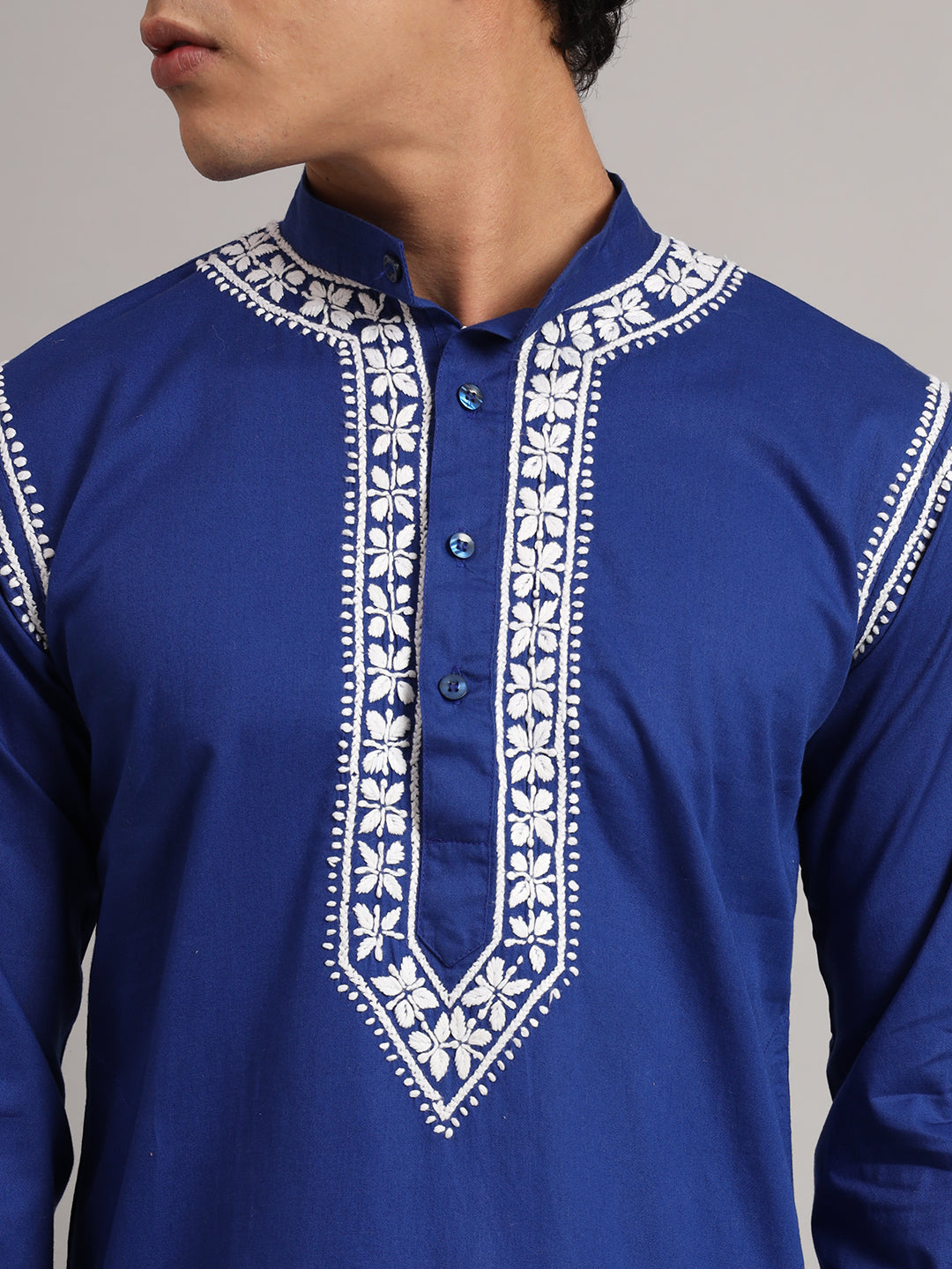 Uman Mens Kurta styled for a regular wear ethnic look, featuring full sleeves, a straight cut and decorative Chikankari embroidery concentrated around the neckline.