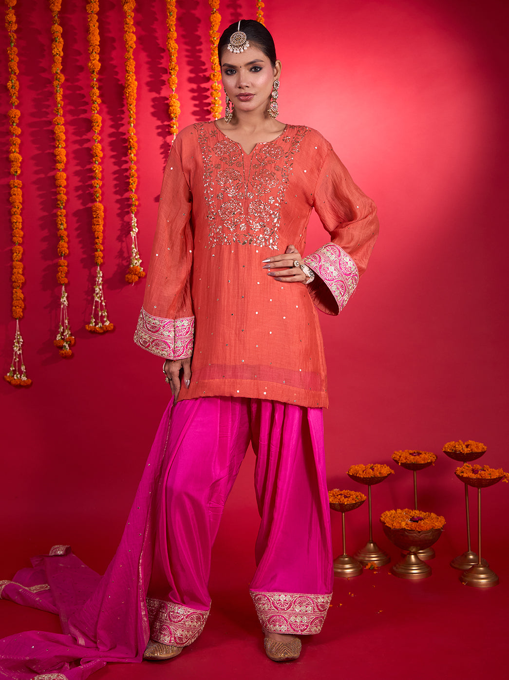 Full-length model photograph highlighting the Noorani Chikankari kurta set’s flowing silhouette, long bordered sleeves and embellished Farshi pants.