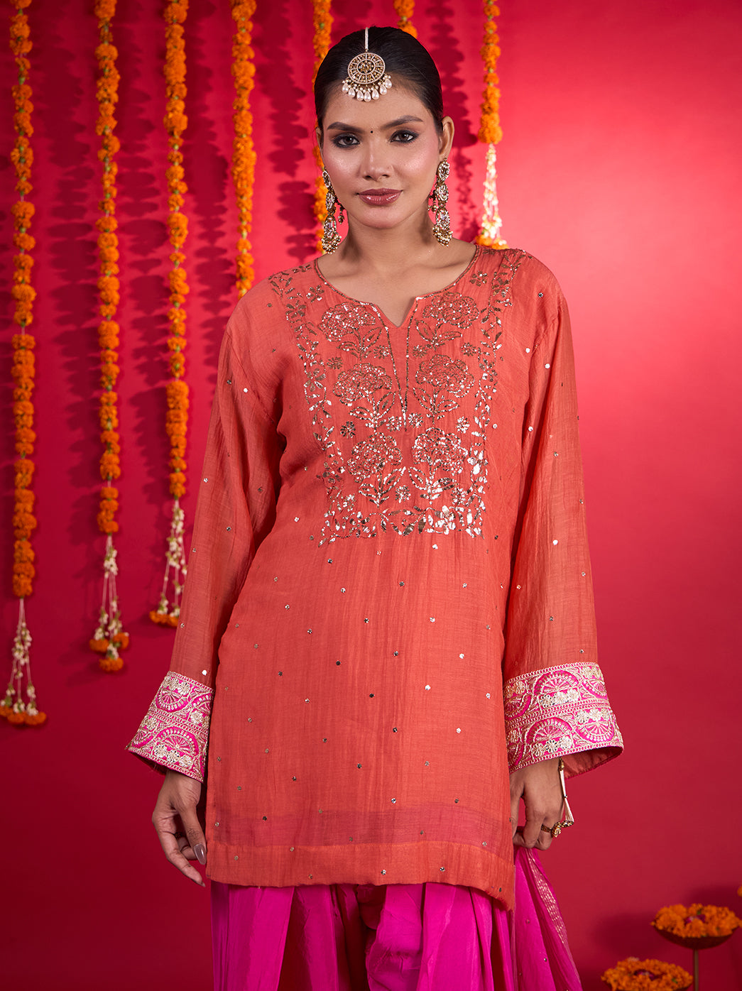 Front view of the Noorani Short Kurti Farshi Set showing floral detailing on the kurti and decorative embroidery along the wide pant hems.