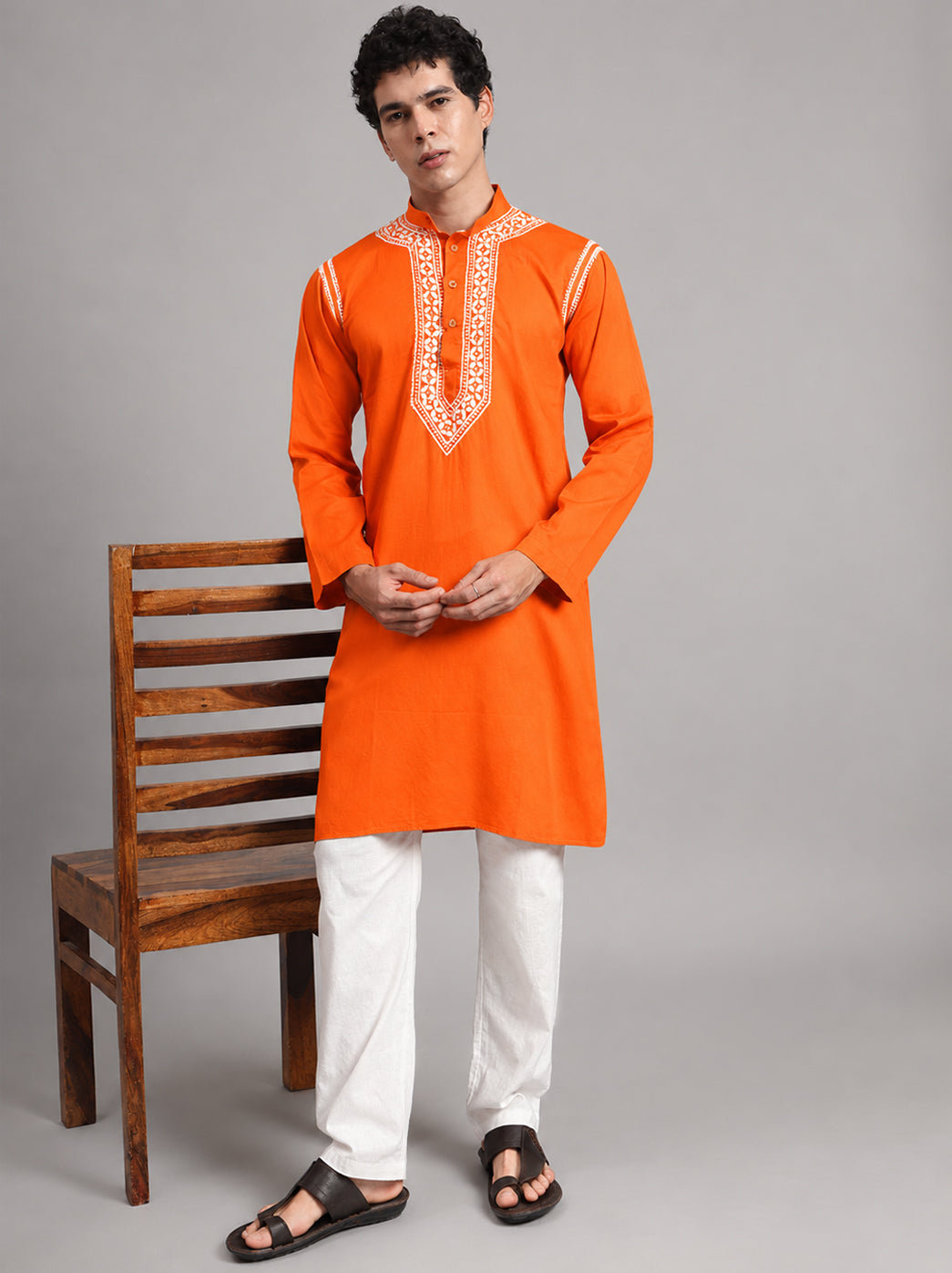 Uman men's Chikankari kurta with an ornate neckline panel and simple sleeve finish, shown from collar to hem as part of a full-length modelled product photograph.