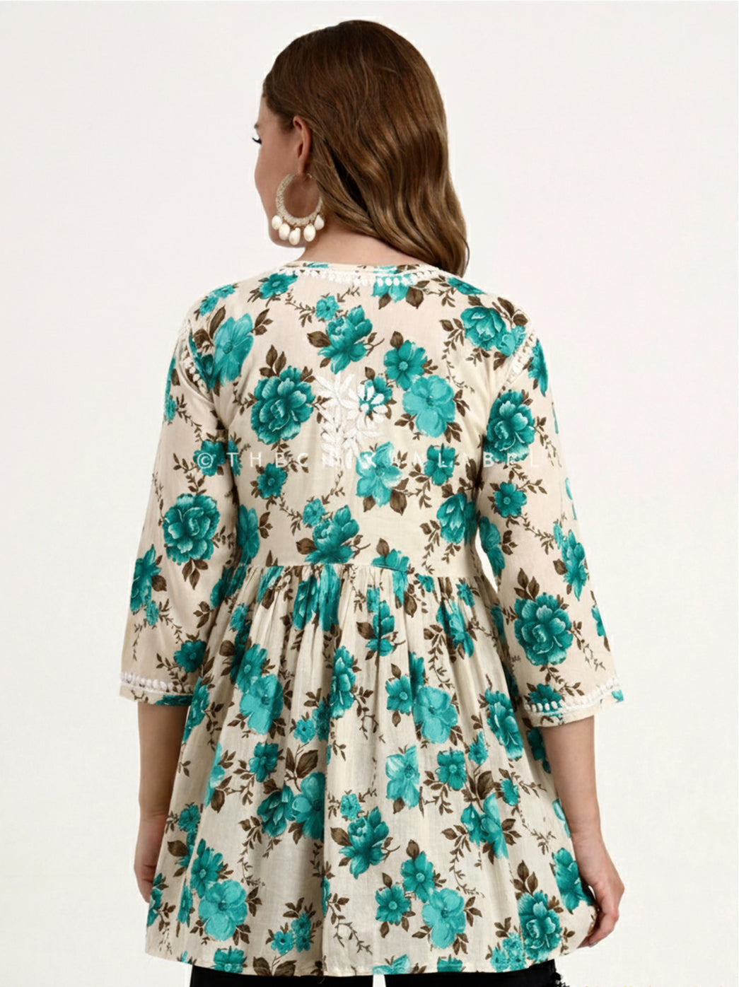 Hand-embroidered Chikankari short top made from breathable mulmul cotton, styled with floral prints and comfort-fit sleeves.