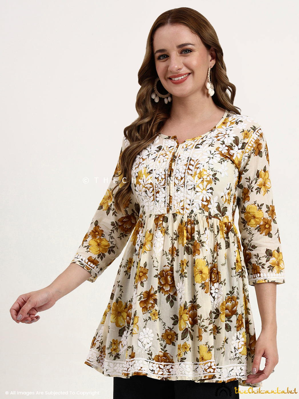 Lightweight mulmul cotton short top with intricate Chikankari work on the yoke and an elegant printed design for women.