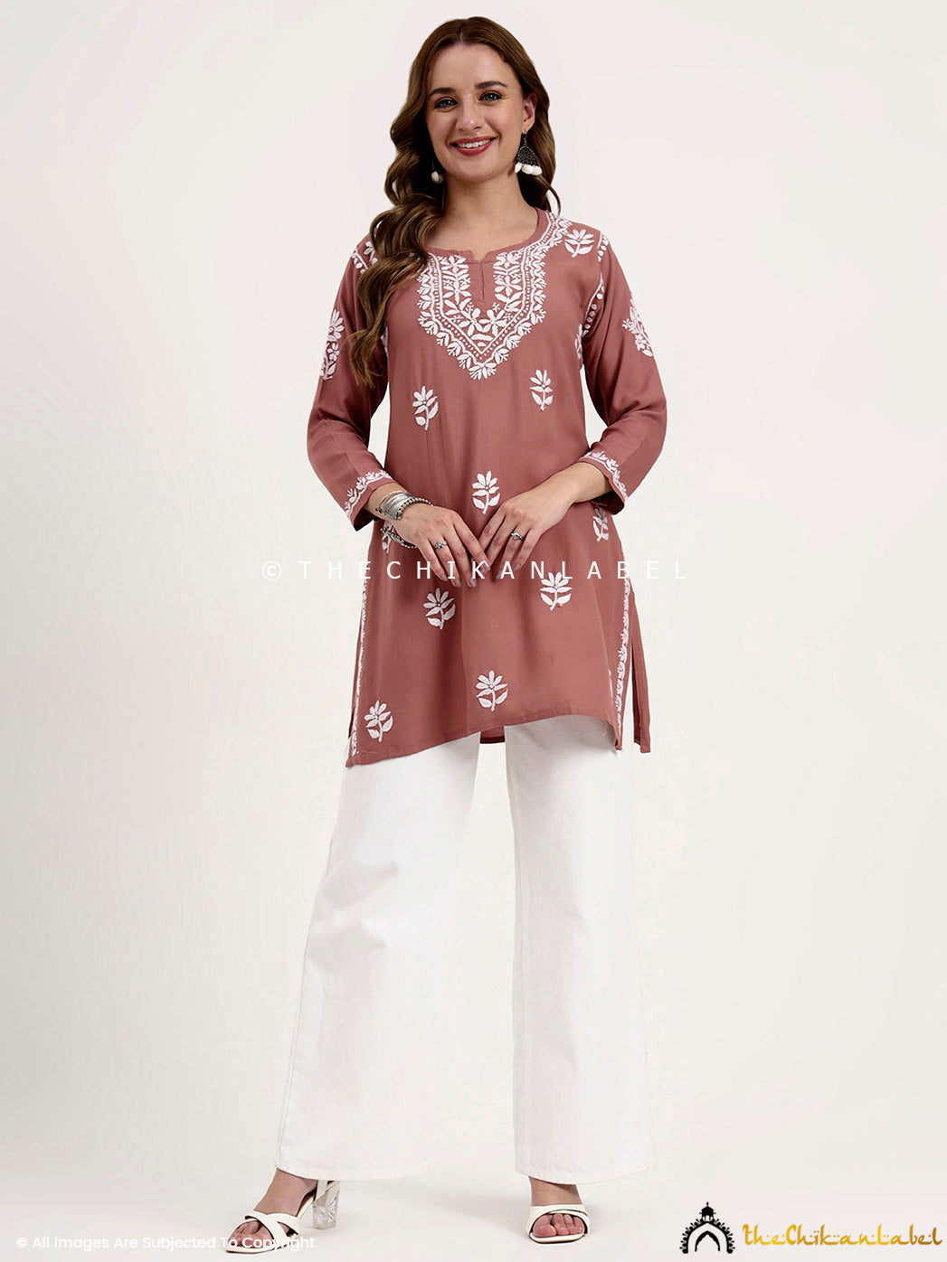 Casual wear rayon short top with detailed chikankari embroidery on neckline.