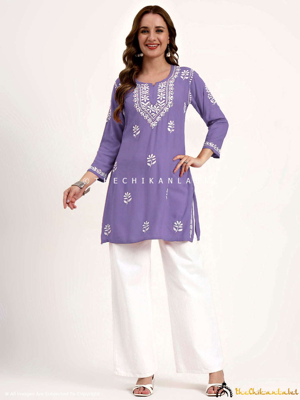 Lightweight rayon chikankari short kurti top with intricate embroidery patterns.