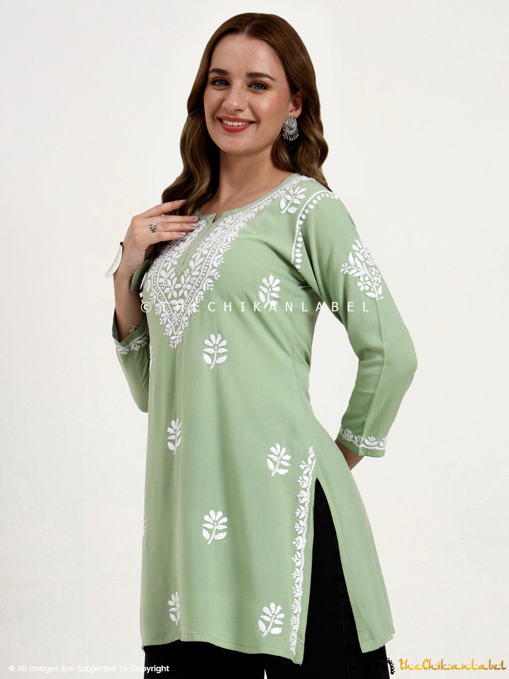 Traditional chikankari embroidered short top in rayon fabric for casual occasions.