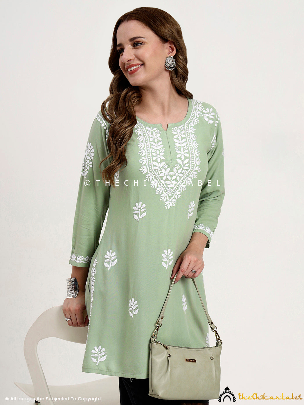 Premium rayon chikankari short top for women with hand embroidery on neckline and sleeves.