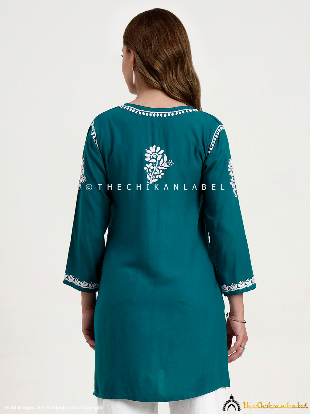 Artisan-made rayon chikankari short top featuring floral hand embroidery on fabric.