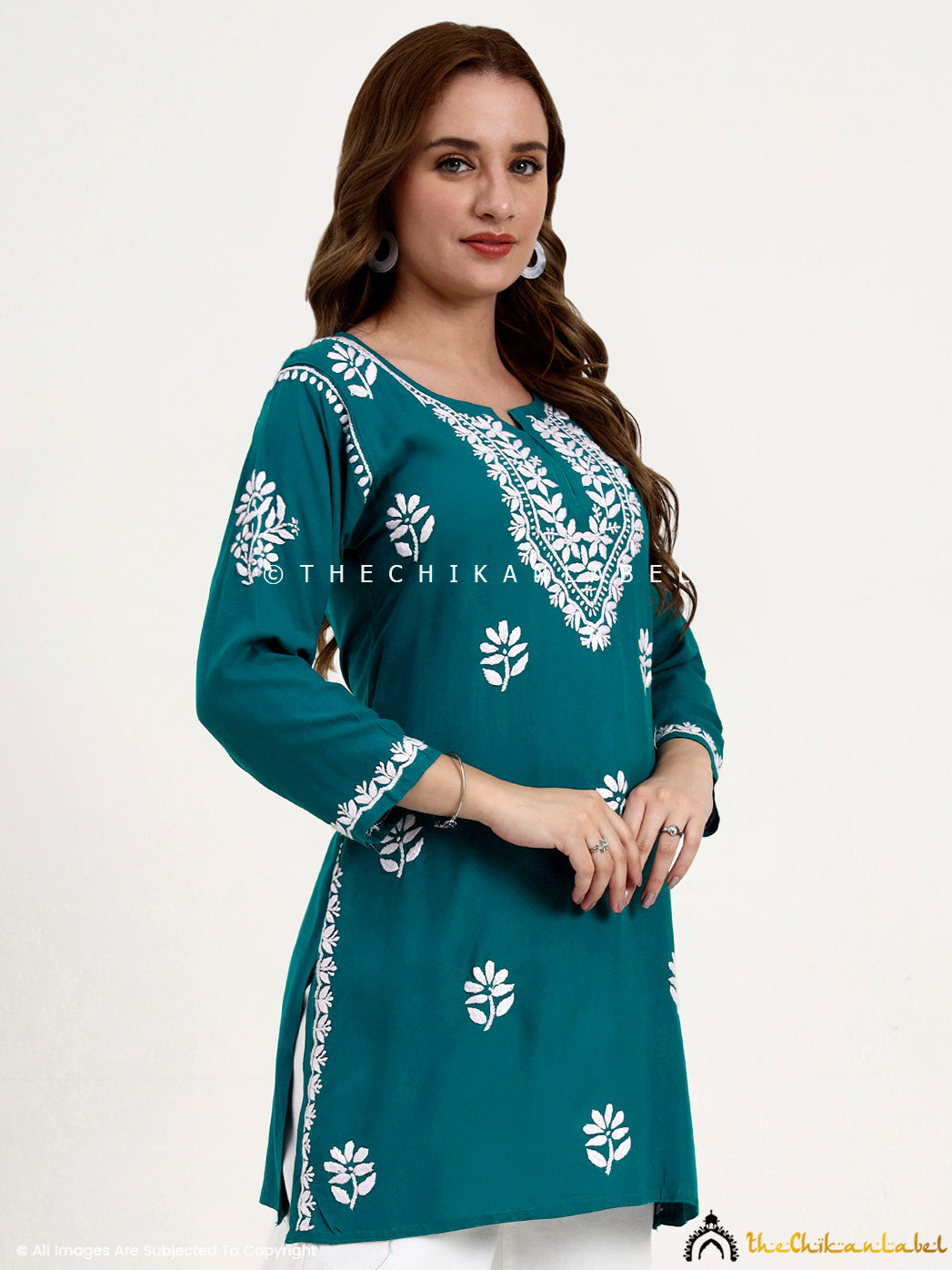 Elegant short kurti top in rayon with chikankari detailing for casual and office wear.