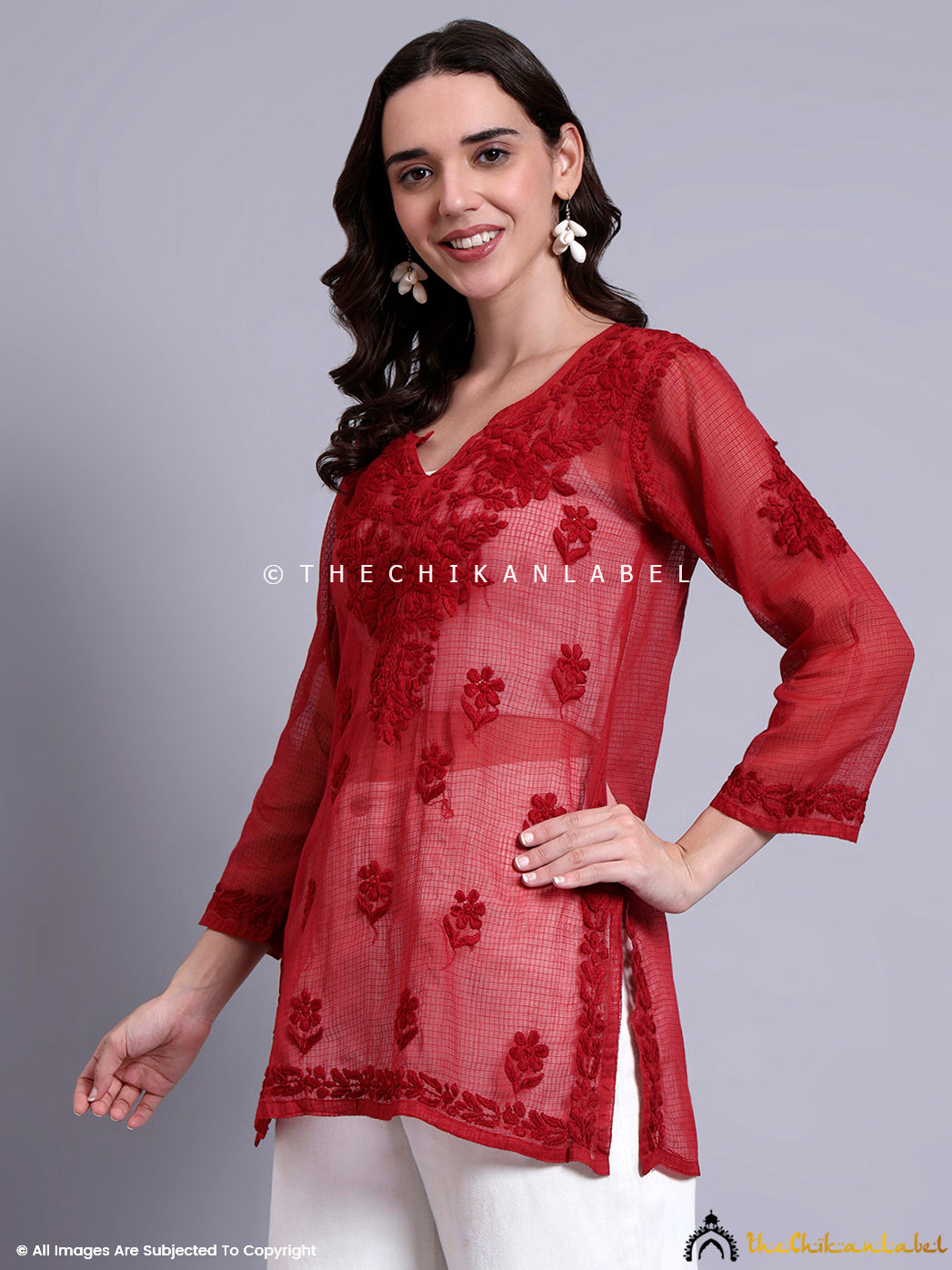 Side-slit Kota cotton short kurta showcasing detailed Chikankari motifs and elegant V neckline.

