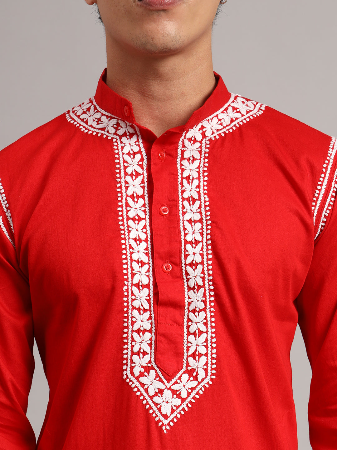Men's Uman Chikankari kurta featuring a mandarin collar, full sleeves and narrow embroidered shoulder accents, styled with straight trousers and open-toe sandals.