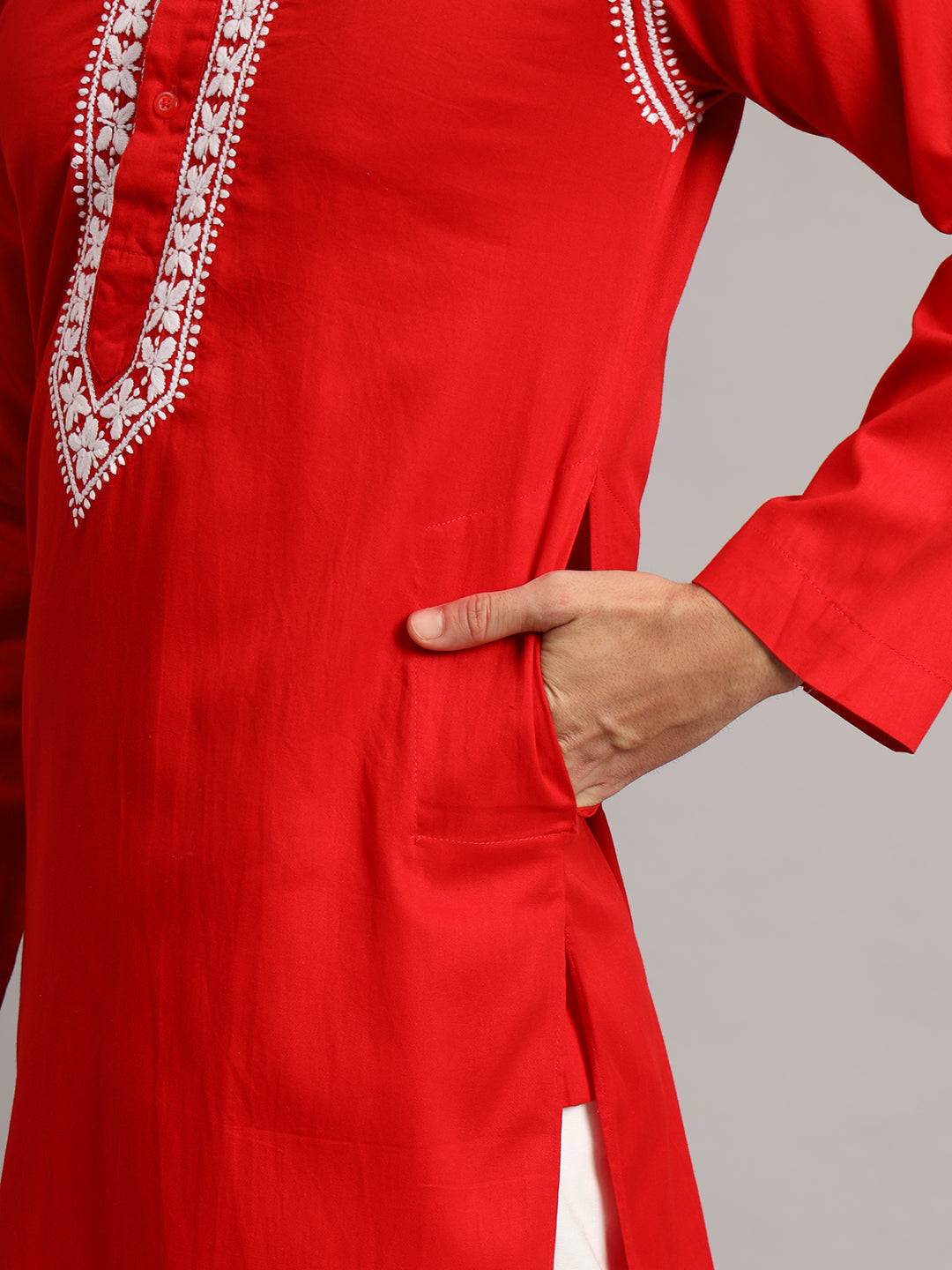 Full-length product photograph of the Uman Mens Kurta, with decorative embroidery framing the neckline and shoulder seams above an otherwise unembellished kurta body.