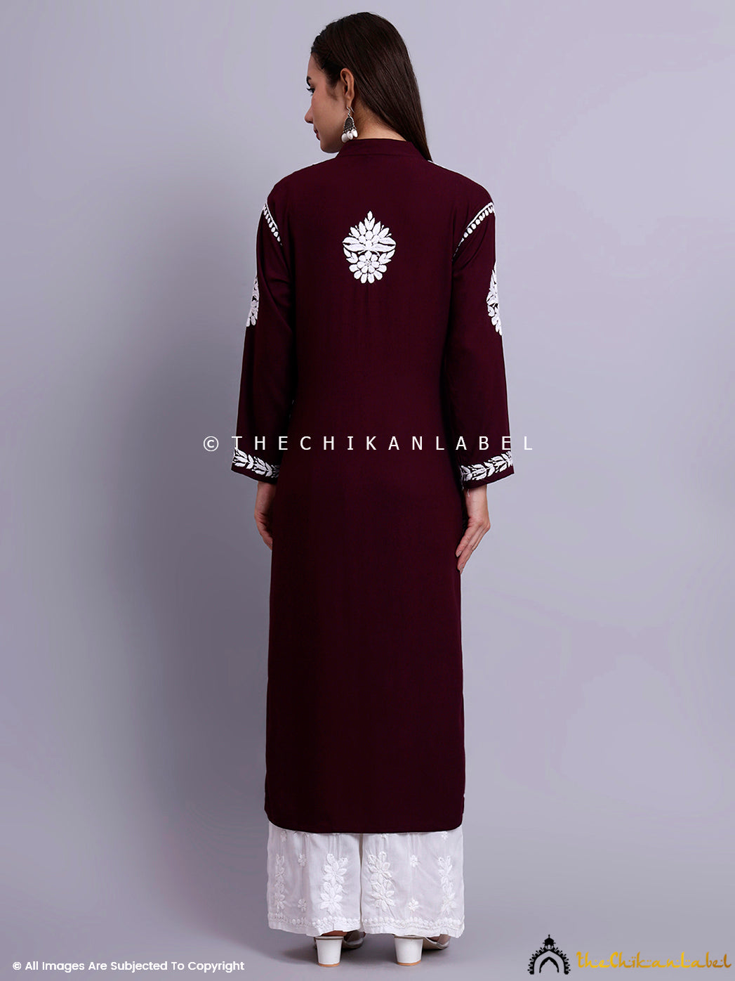 High-resolution image of women’s ethnic kurti with detailed embroidery along neckline and cuffs.


