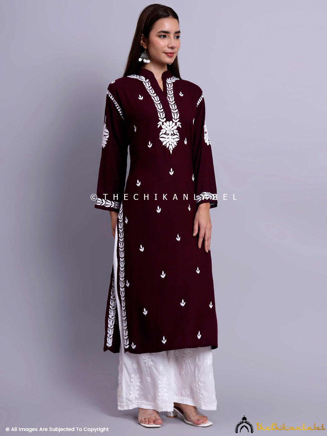 Woman wearing a rayon chikankari straight kurti with mandarin collar styled with embroidered palazzo pants.

