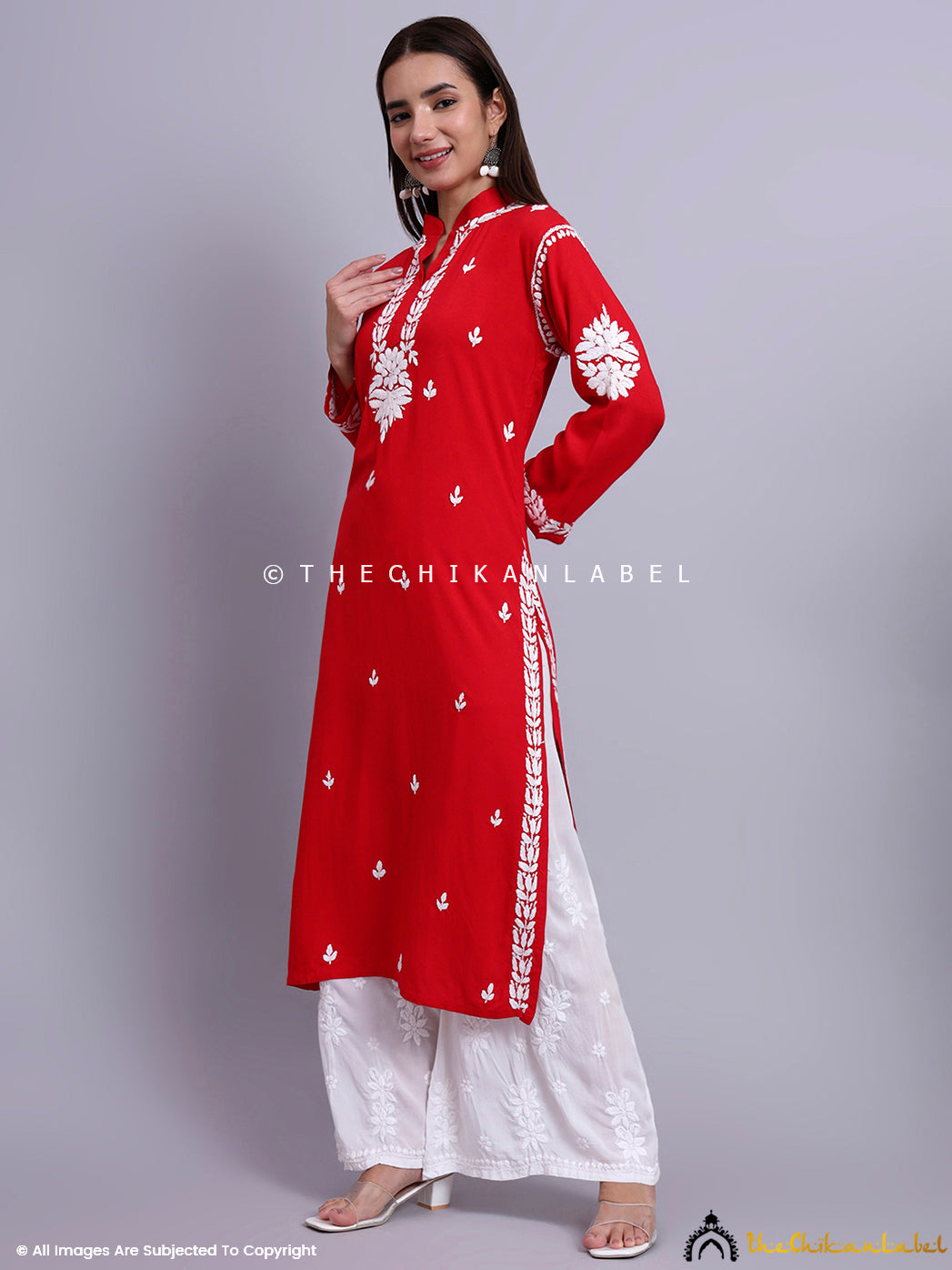 Stylish long kurti with straight cut and handcrafted embroidery styled in a graceful pose.

