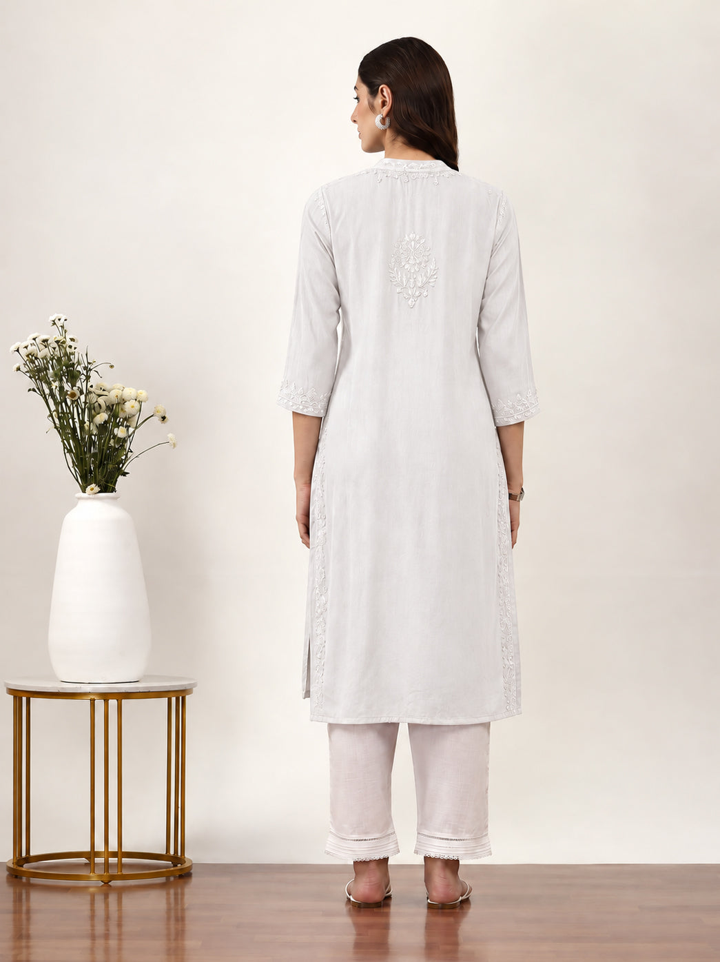 Elegant regular wear kurti featuring detailed Chikankari embroidery, three-quarter sleeves, round neckline and straight-fit styling for everyday ethnic fashion