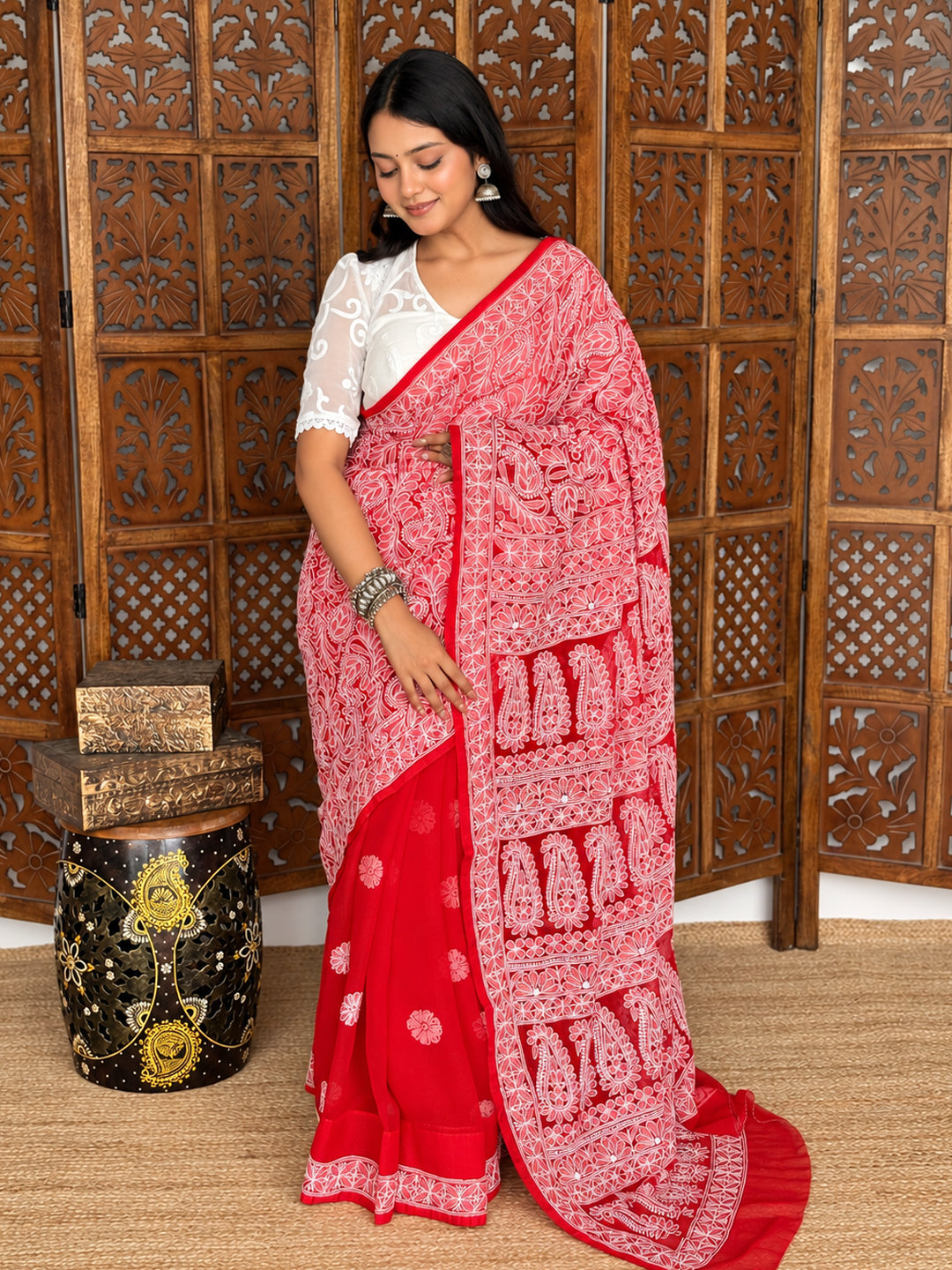 Front view of the Sahira Georgette Half Jaal Saree styled with traditional jewellery, showing the contrast between dense pallu embroidery and scattered pleat motifs.