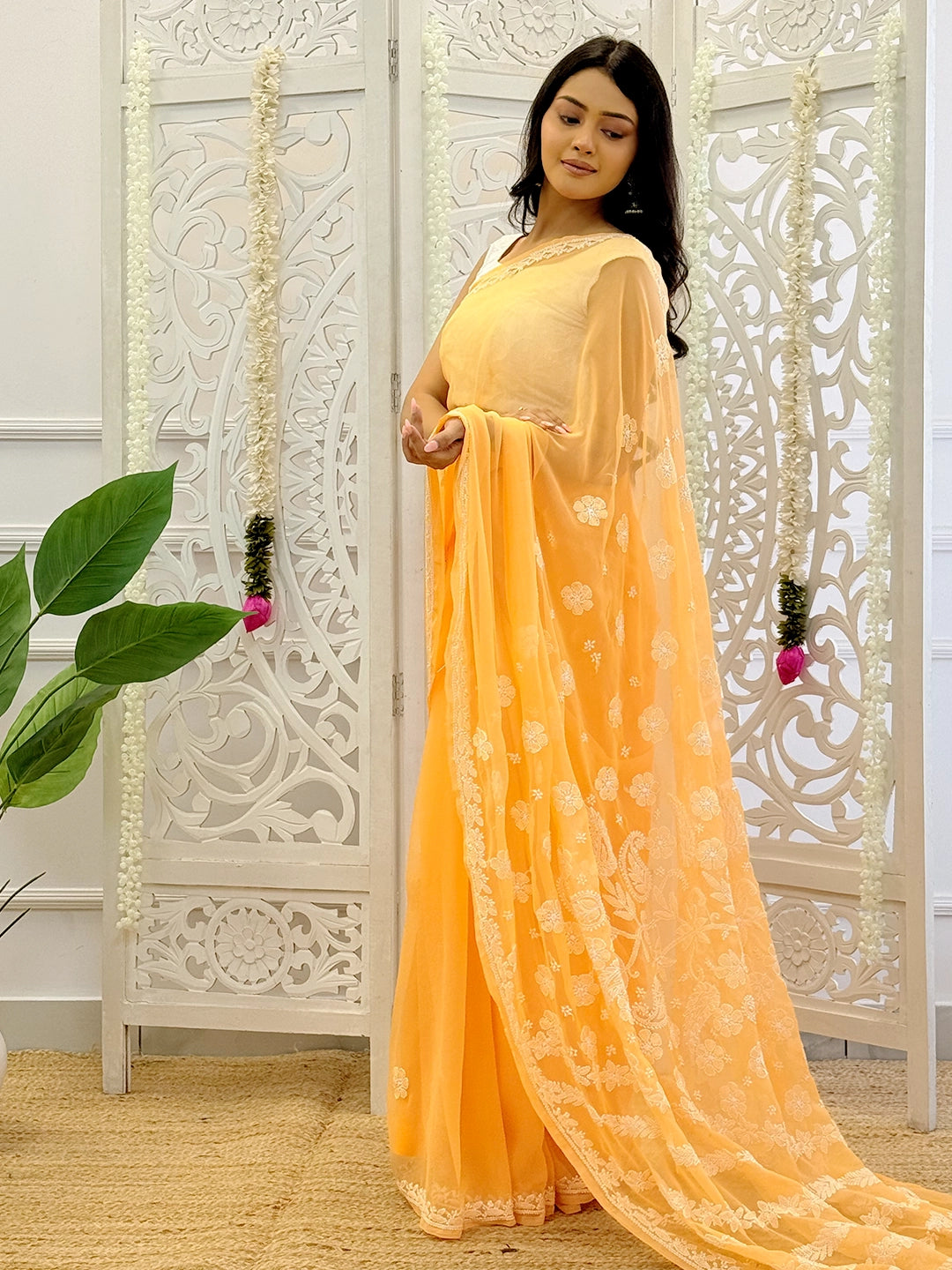 Model showcasing elegant georgette chikankari saree with intricate half-jaal embroidery work and traditional Indian design.