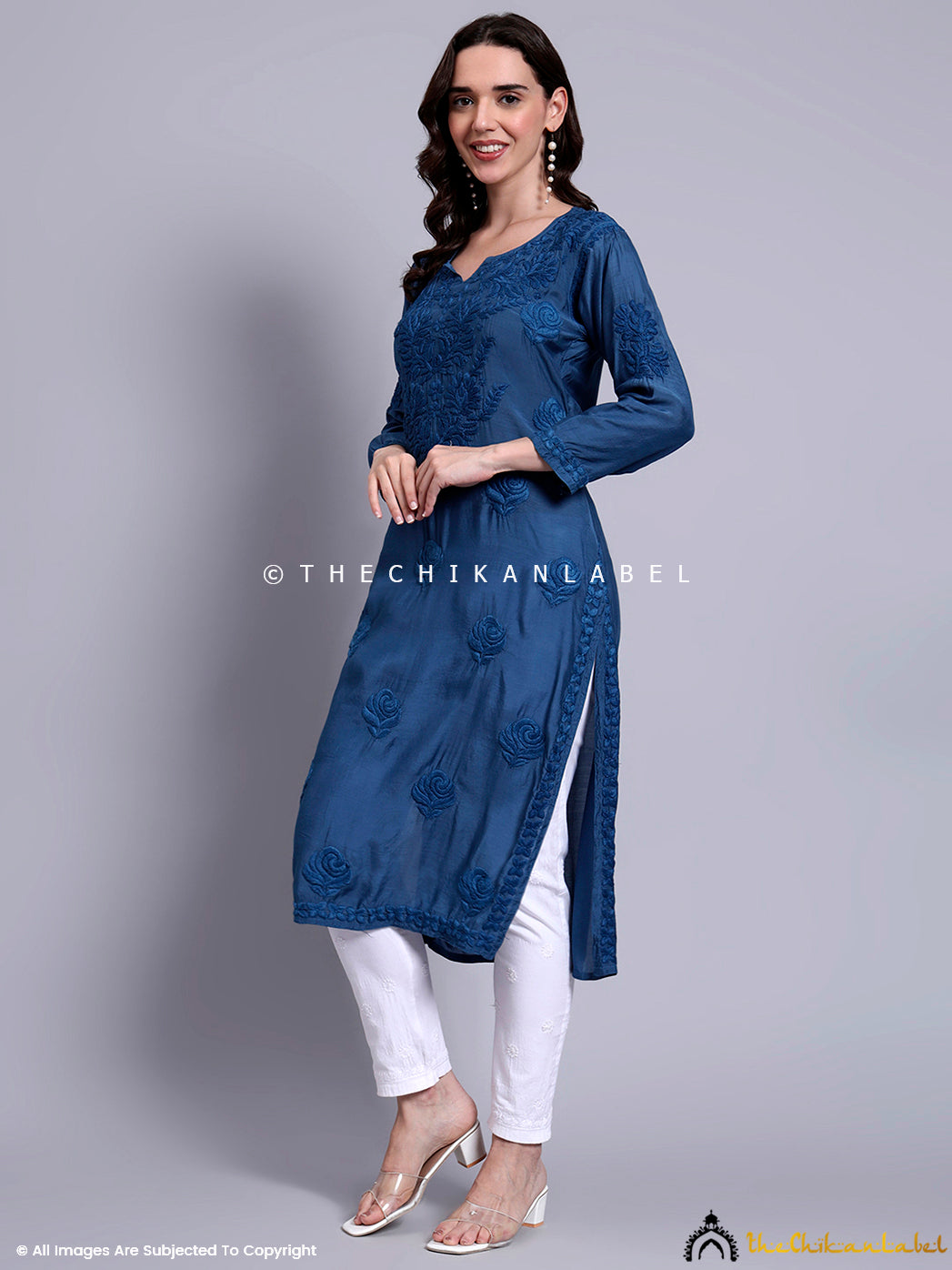 Artisanal muslin straight kurti with side slits and handcrafted embroidery, perfect for festive gatherings, cultural events, and everyday wear.

