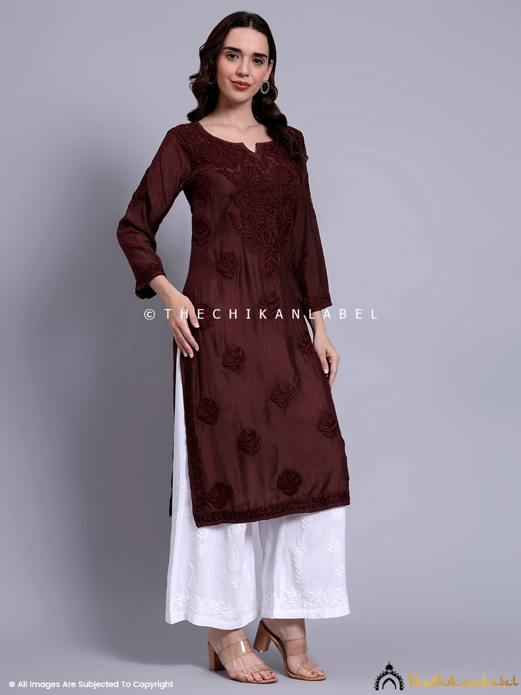 Elegant straight-fit kurti with full sleeves and handcrafted floral motifs, perfect for traditional wear with a modern touch.

