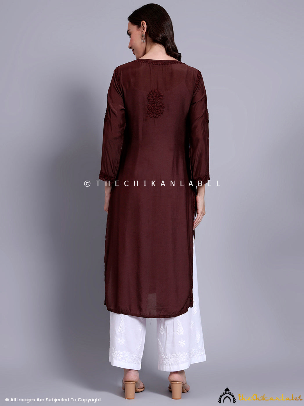 Full-body view of a woman wearing a muslin chikankari straight kurti with delicate hand embroidery, ideal for daily ethnicwear and festive styling.


