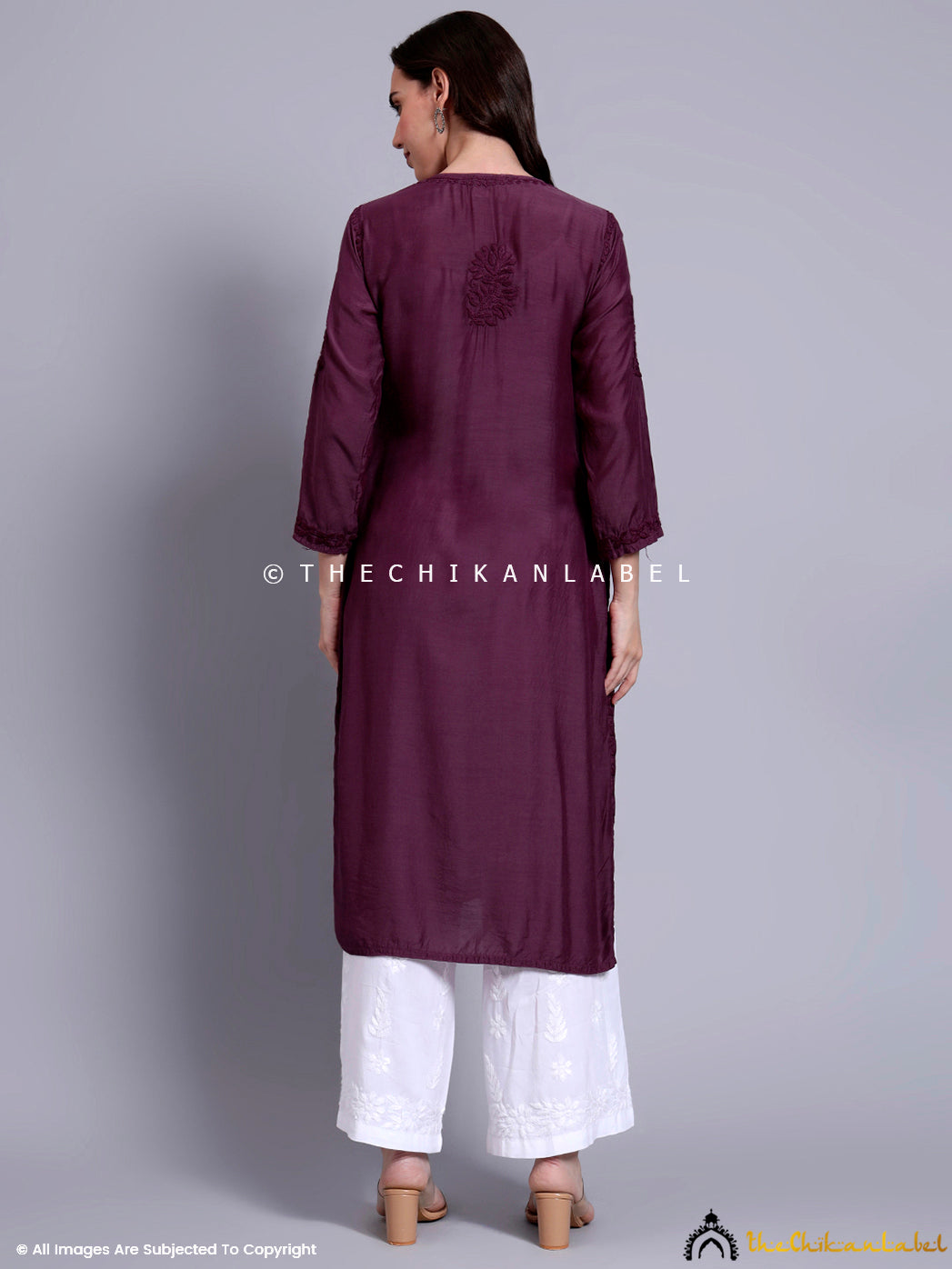 Indian ethnicwear featuring straight muslin kurti with intricate needlework and long sleeves, styled with flats and minimal makeup.

