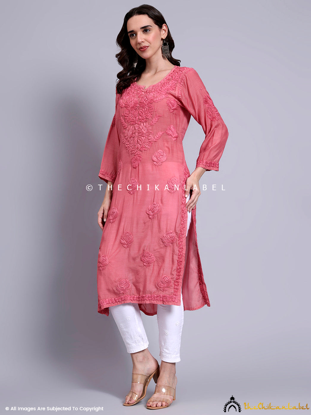 Full-length image of model styled in traditional chikankari kurti made of lightweight muslin fabric, featuring hand embroidery and straight-fit silhouette.

