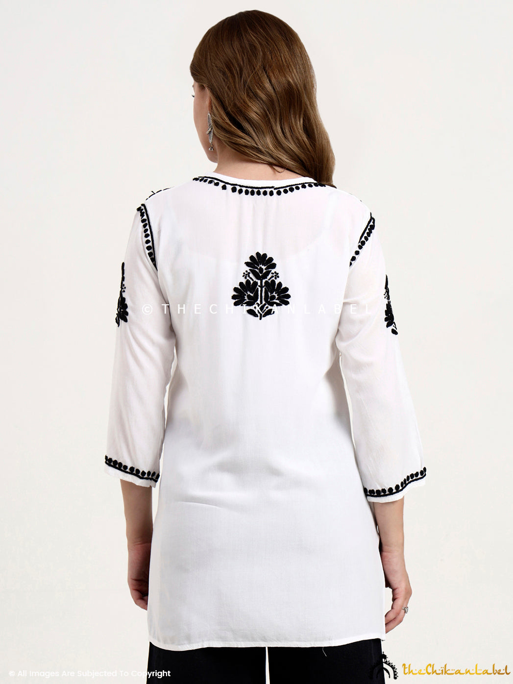 Elegant rayon short tunic top with intricate chikankari embroidery, perfect as an ethnic wear top for women.