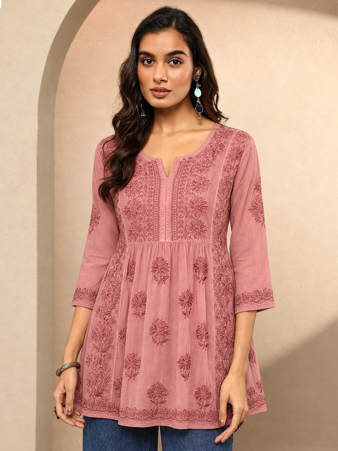 Sara floral embroidered kurti with a structured front yoke, decorative vertical embroidery, three-quarter sleeves with embroidered cuffs, and a flowing A-line lower section.