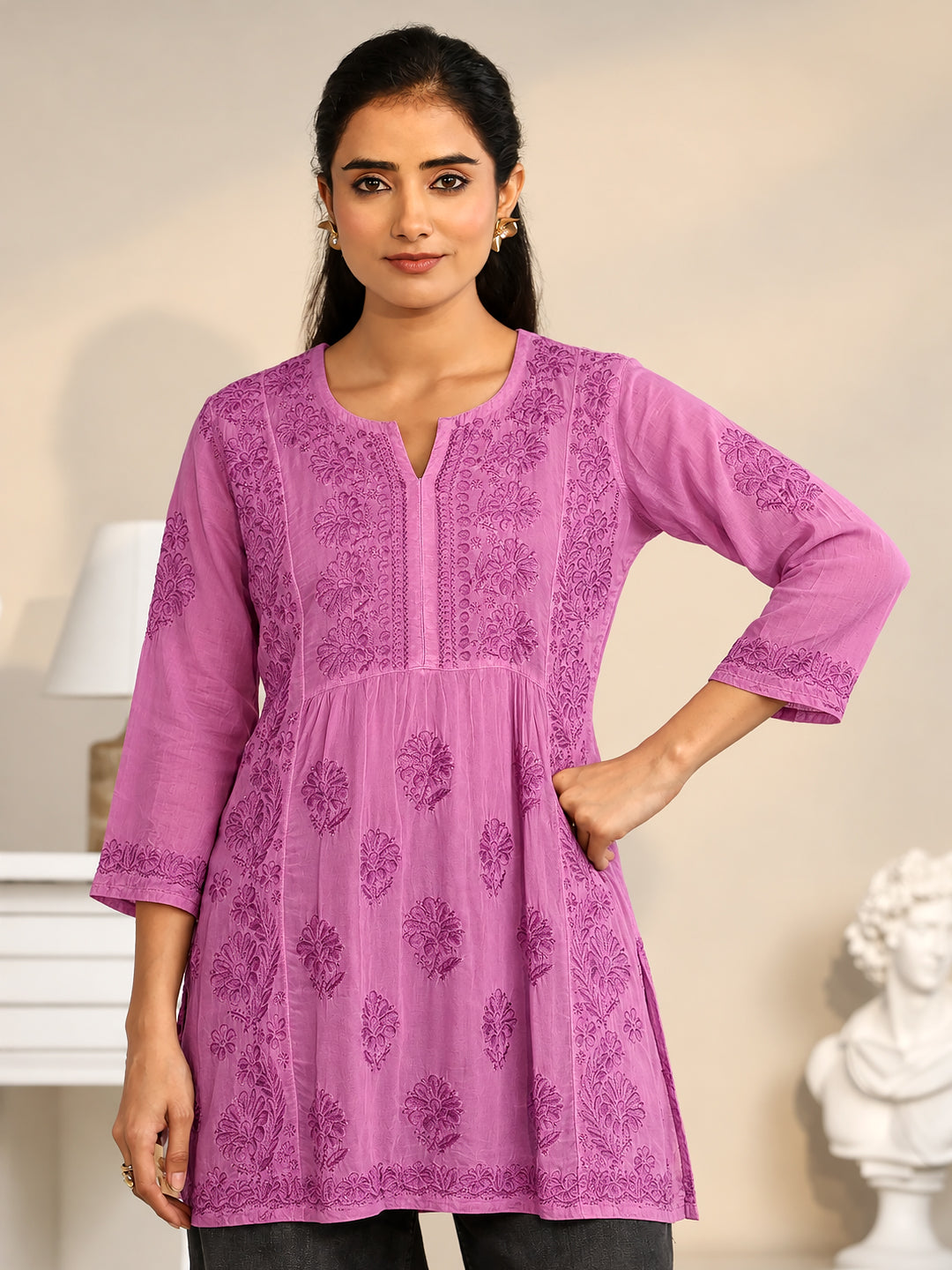 Stylish short ethnic kurti for women featuring a flared A-line silhouette, three-quarter sleeves, a V-slit neckline, and elaborate floral Chikankari embroidery.