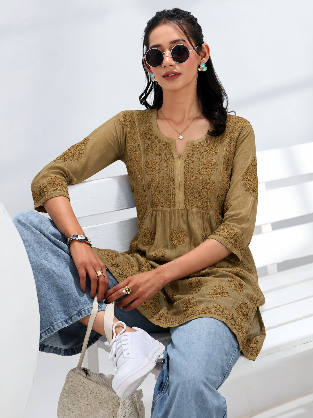 Elegant viscose silk short A-line kurti with intricate Chikankari-style floral motifs, a V-slit neckline, decorative front embroidery, and a beautifully finished hemline.