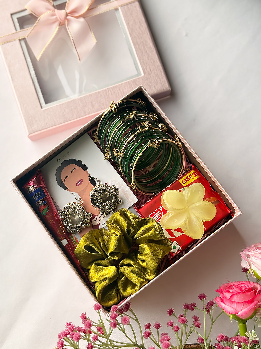 Sawan special gift hamper for sister, wife or friend with festive accessories, jewellery, beauty essentials and chocolate in elegant packaging.