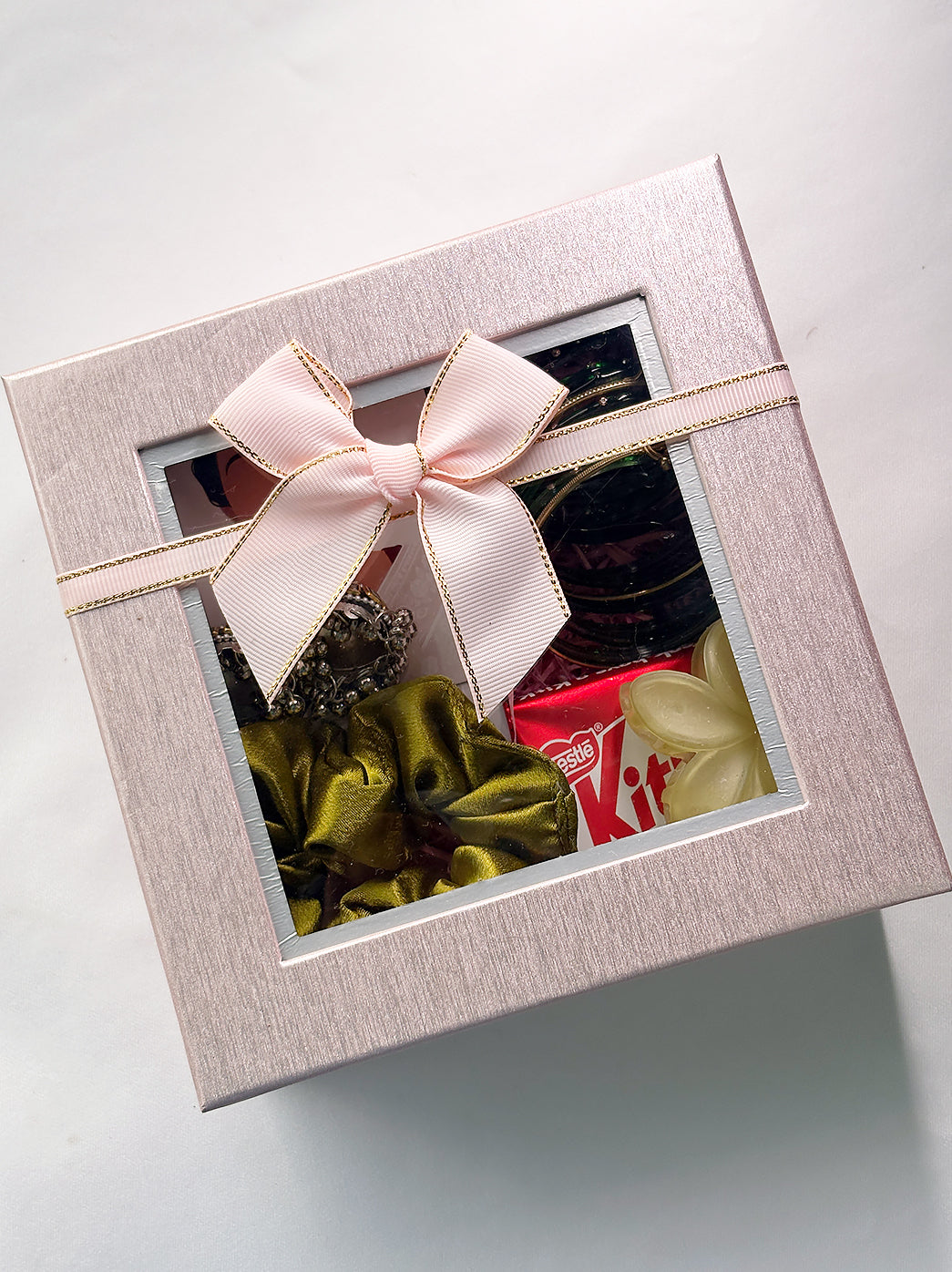 Festive Sawan gift hamper arranged in a premium gift box with traditional jewellery, hair accessories, mehndi, bindi and a sweet chocolate treat.