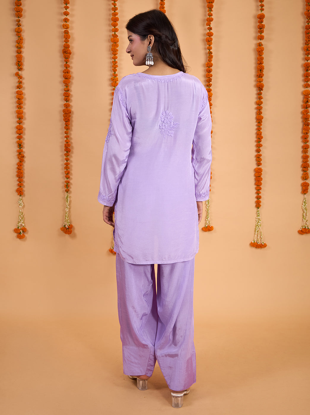 Shagun Muslin Short Kurti Farshi Set shown on a model, highlighting the rounded neckline with slit detail, floral embroidery and relaxed trouser silhouette.
