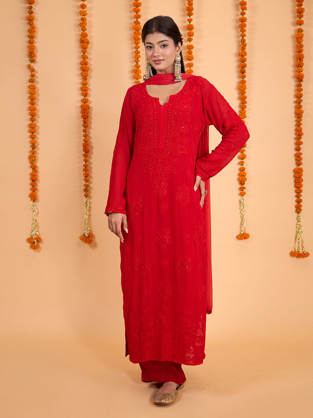 Model wearing the Shahana Viscose Straight Kurti Palazzo Set with Dupatta, featuring tonal Chikankari embroidery, full sleeves and a rounded neckline with slit detailing.