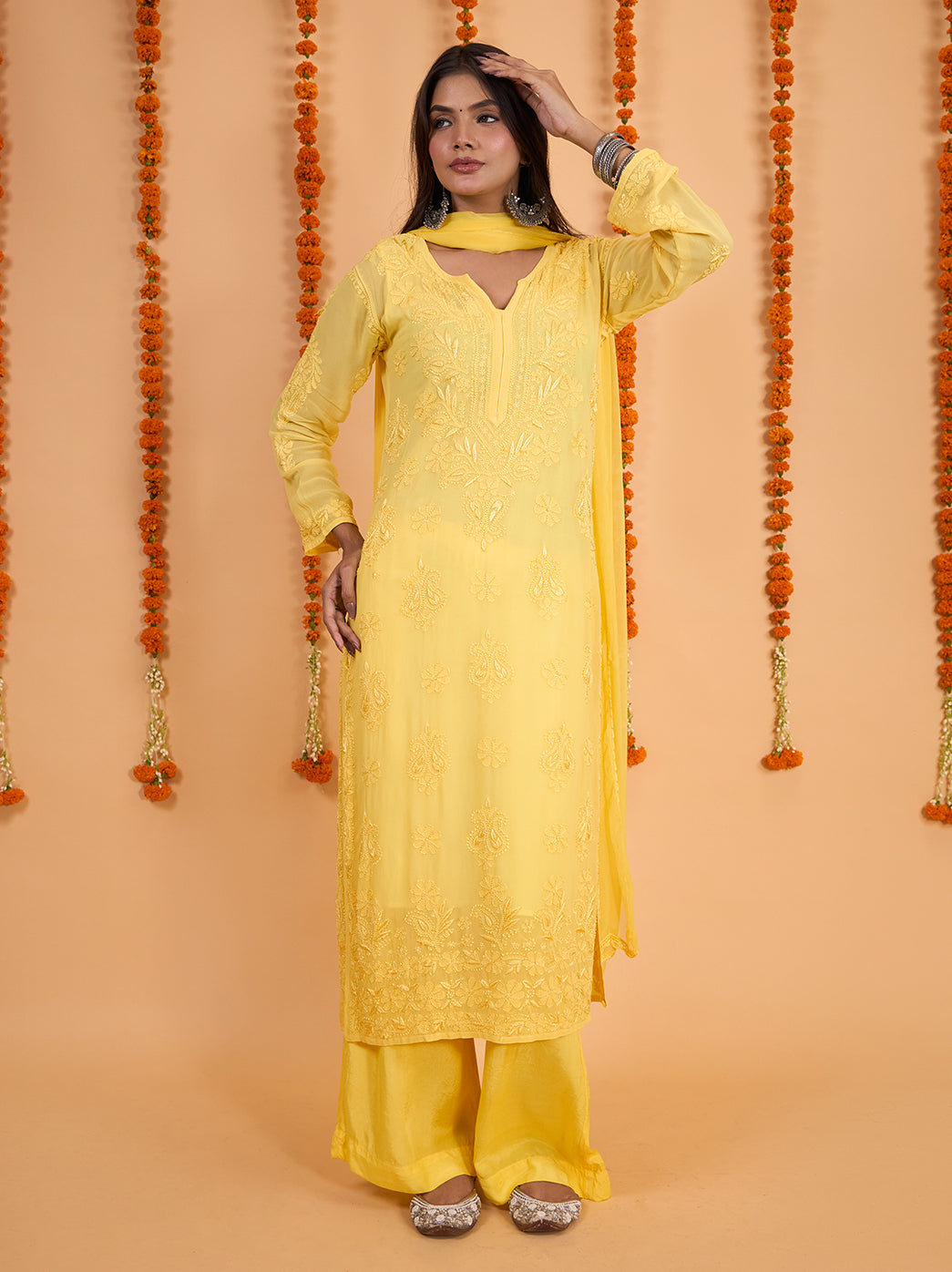 Three-piece Shahana ethnic wear set featuring a long straight kurti with tonal embroidery, matching palazzo bottoms and a softly draped coordinating dupatta.