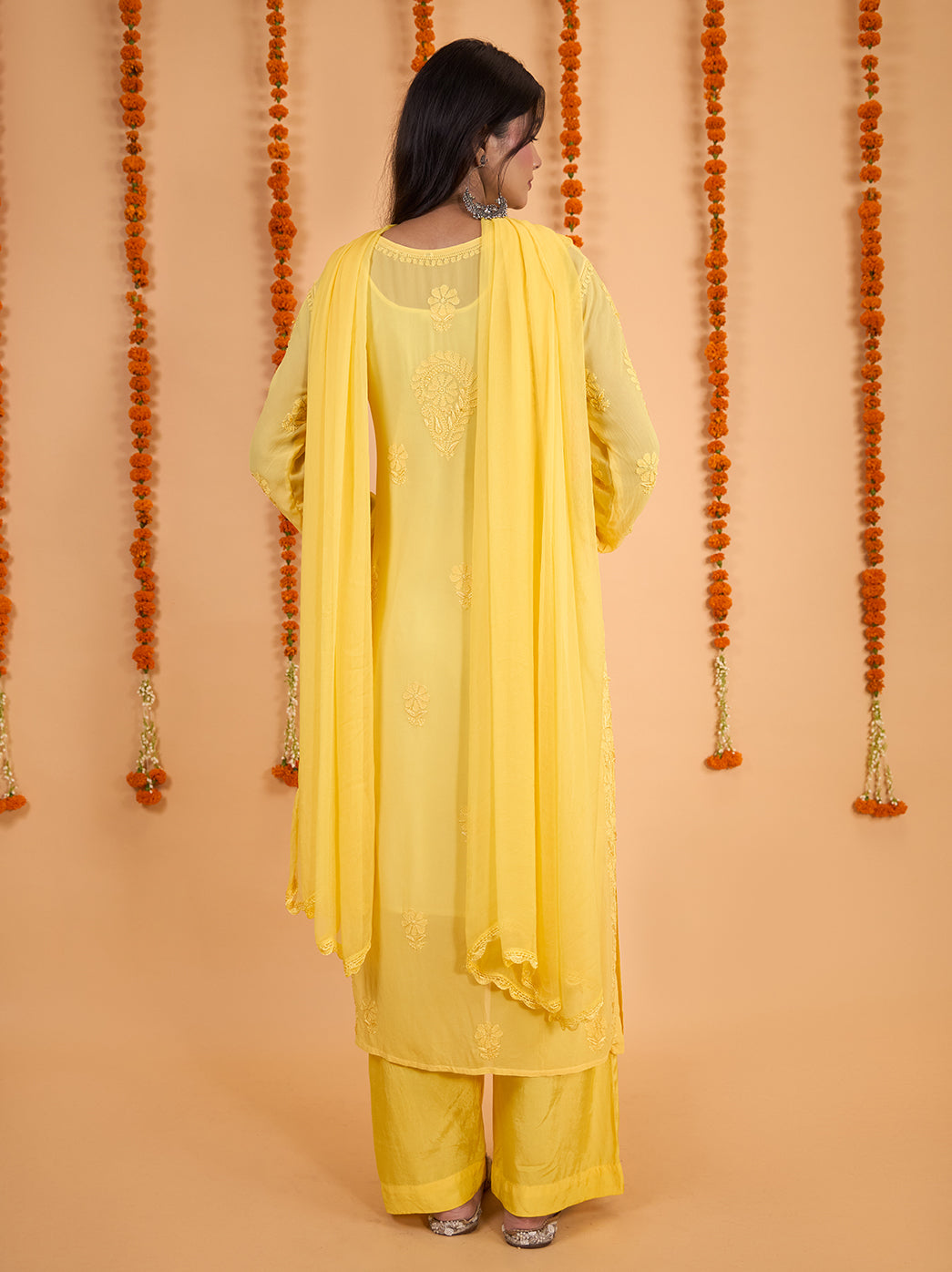 Shahana straight viscose kurti featuring a rounded neckline with an elongated slit, floral Chikankari detailing and matching palazzo pants beneath the embroidered hem.