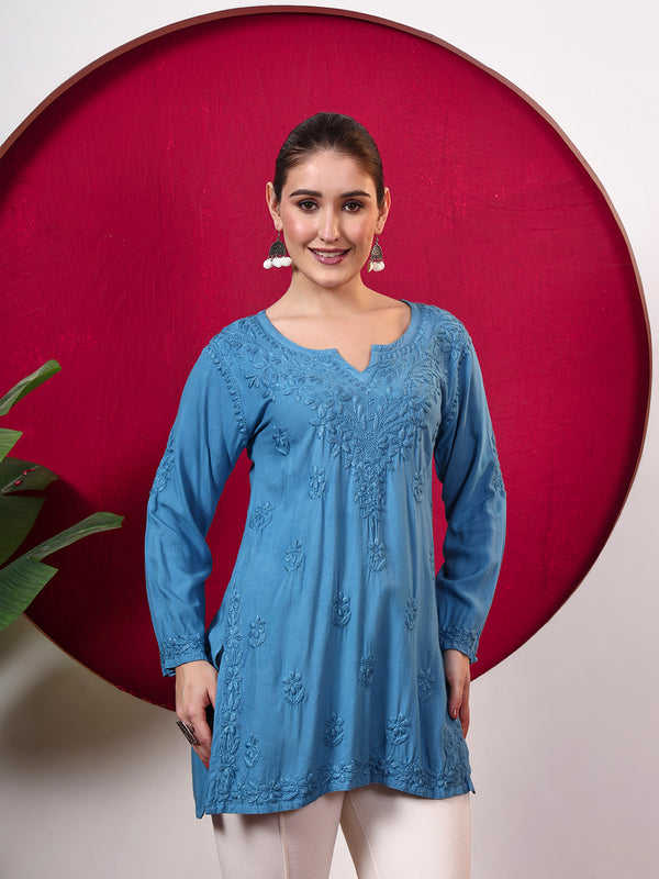 Female model wearing the Shruti Rayon Short Kurti featuring detailed Chikankari embroidery, full sleeves, a notched neckline and a relaxed silhouette for comfortable everyday wear.