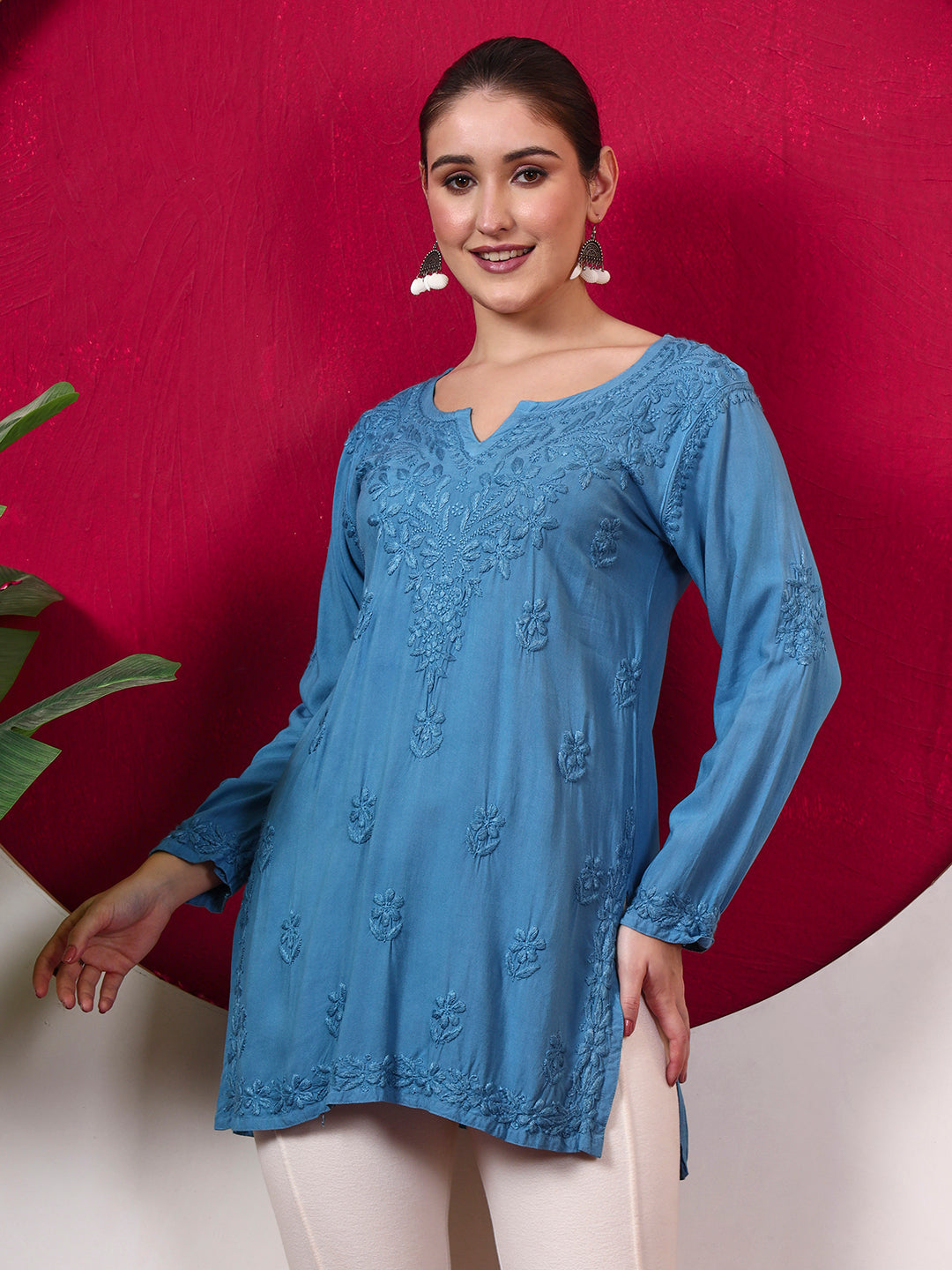 Model showcasing the Shruti Rayon Short Kurti with traditional Chikankari-inspired embroidery, full sleeves and an easy short-kurti silhouette ideal for everyday ethnic styling.
