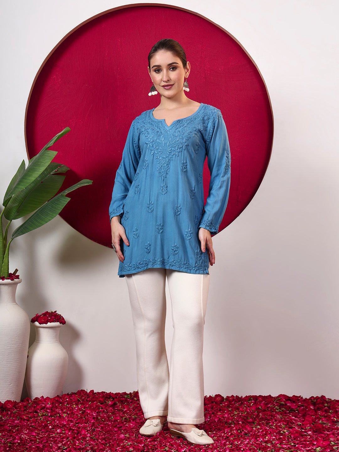 Trending Chikankari top for women featuring detailed floral embroidery, a notched round neckline, full sleeves and lightweight rayon fabric for comfortable regular wear.
