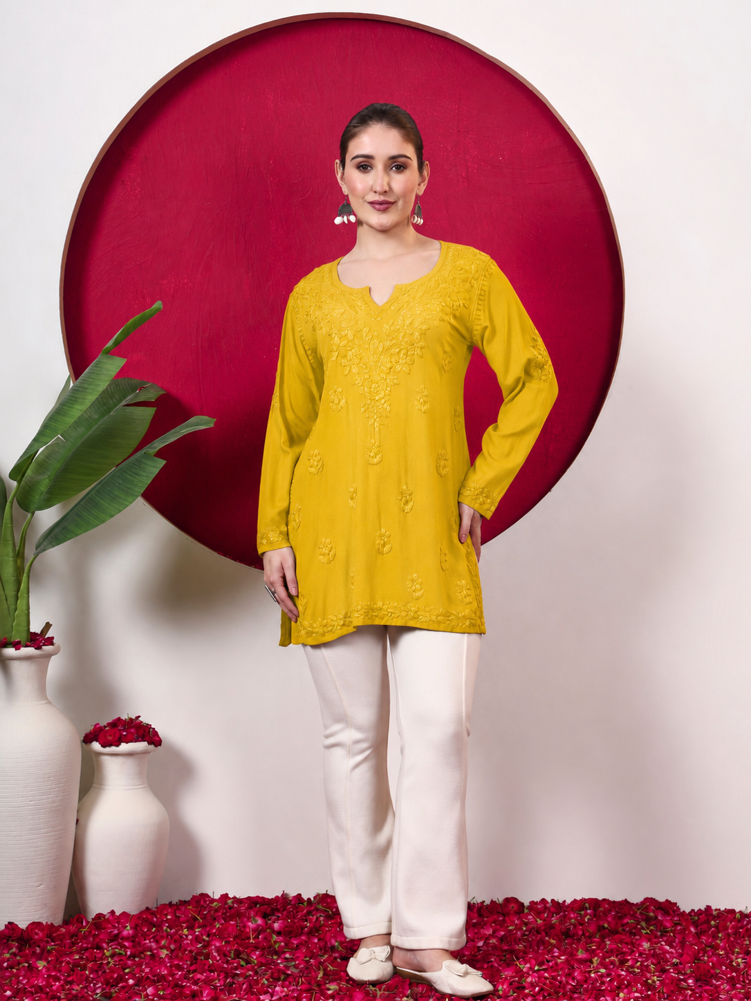 Model showcasing the Shruti Rayon Short Kurti with traditional Chikankari-inspired embroidery, full sleeves and an easy short-kurti silhouette ideal for everyday ethnic styling.