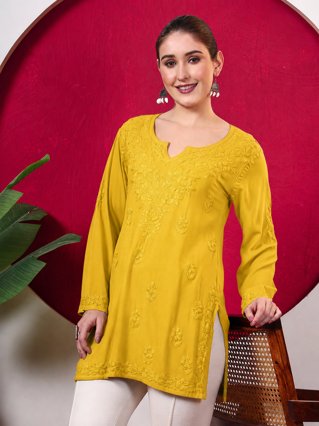 Trending Chikankari top for women featuring detailed floral embroidery, a notched round neckline, full sleeves and lightweight rayon fabric for comfortable regular wear.