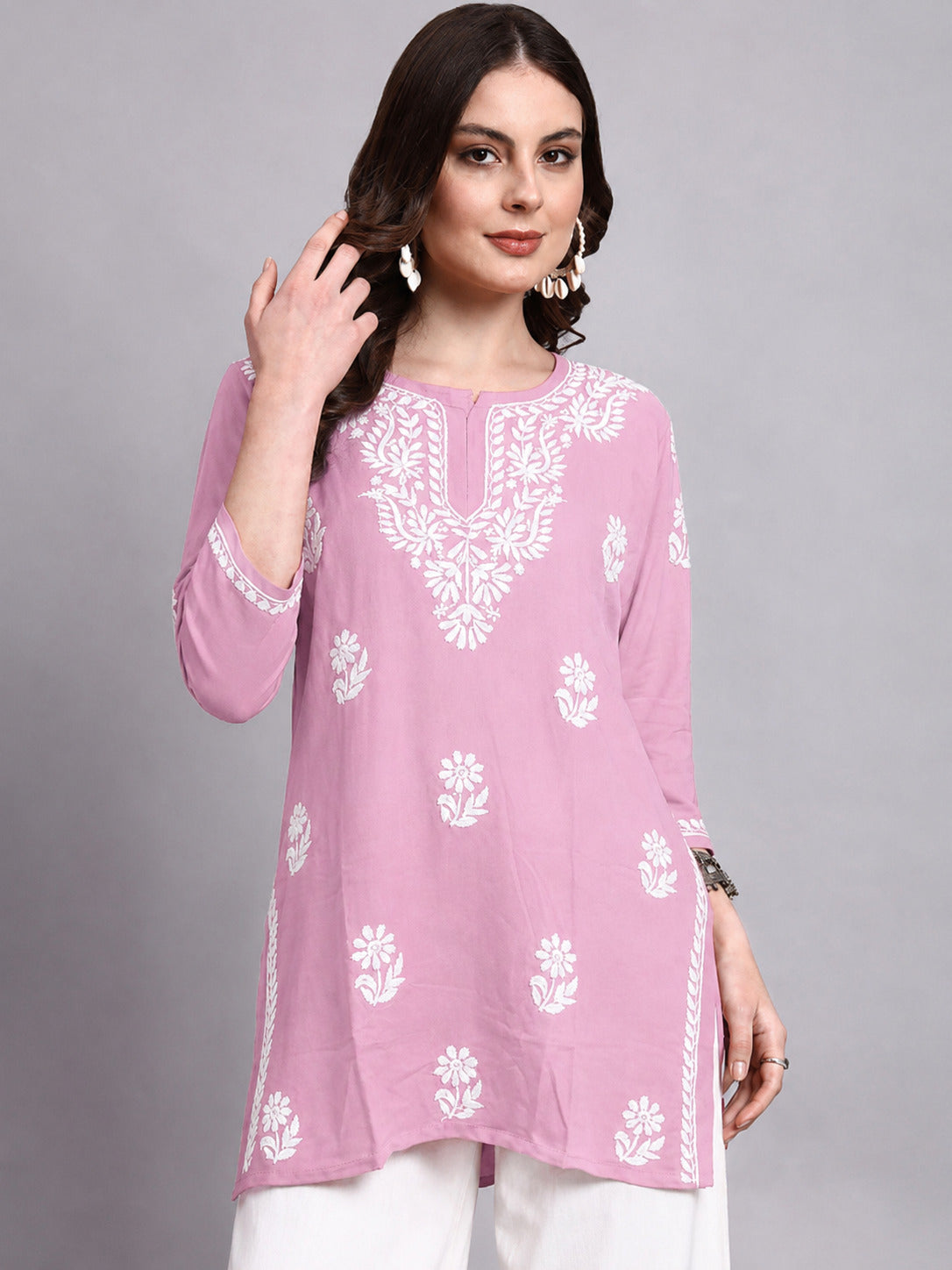 Women’s trending short kurta featuring Chikankari floral embroidery, soft rayon material, notched neckline and 3/4 sleeves for an elegant everyday ethnic look.