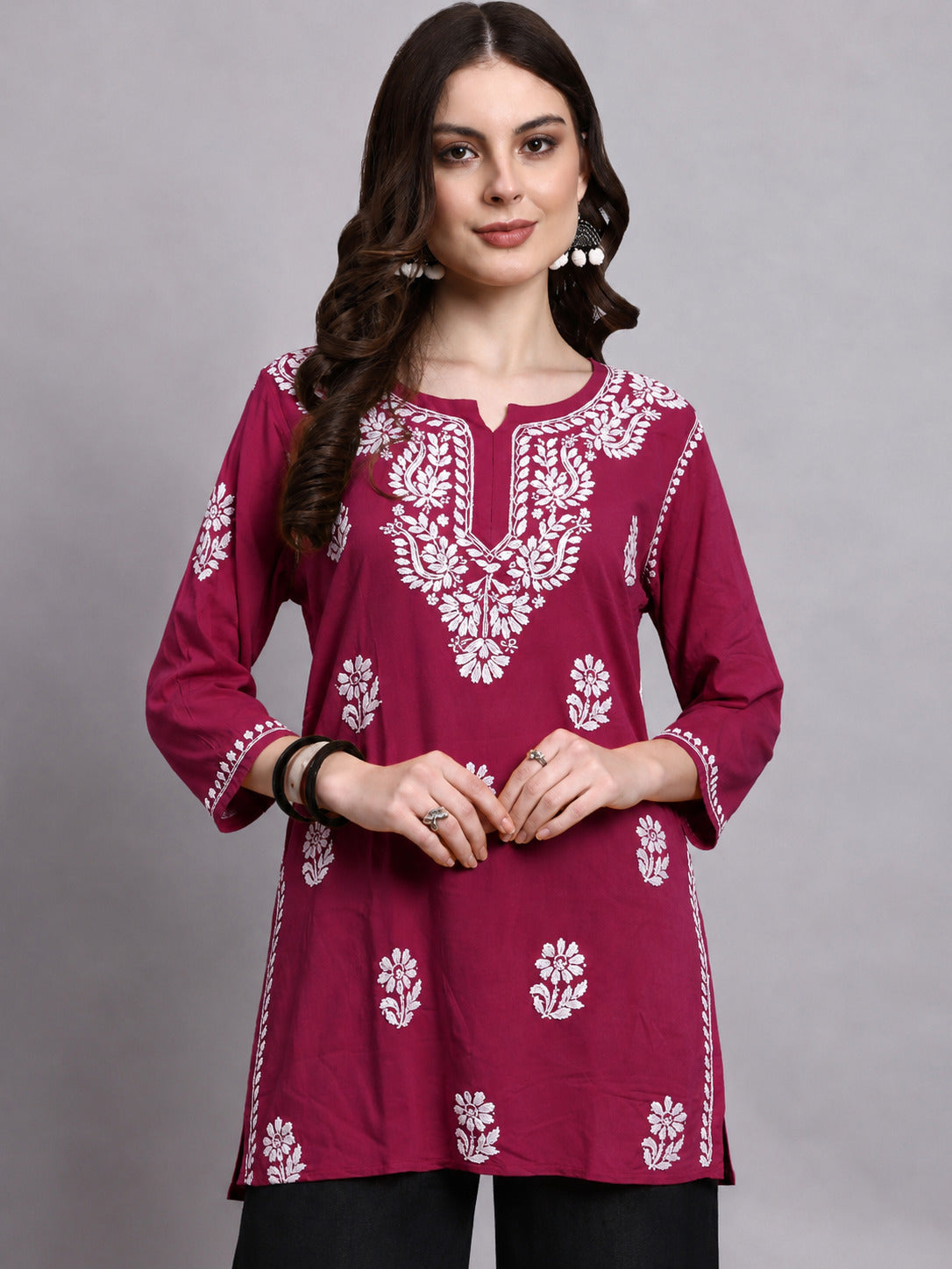 Trending Chikankari short kurta for women featuring floral embroidery, lightweight rayon fabric and a versatile design that pairs easily with jeans and trousers.