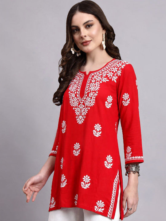 Comfortable regular wear top for women featuring traditional Chikankari embroidery, notched round neckline and an easy-to-style short kurta design.
