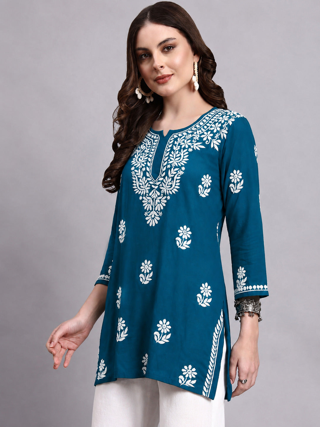 Women’s rayon Chikankari short top with elegant embroidered neckline, floral motifs and three-quarter sleeves for effortless casual and semi-ethnic styling.