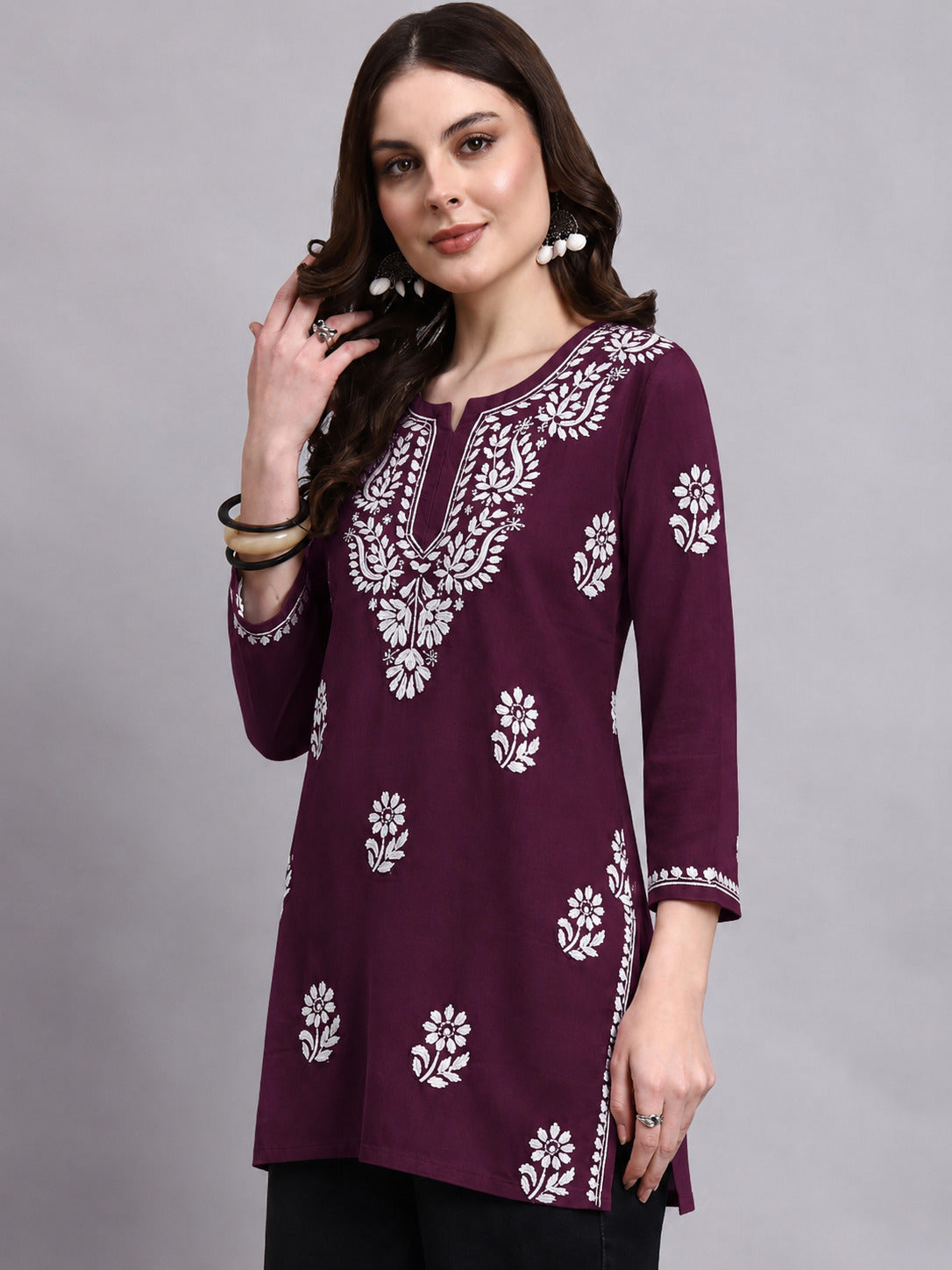 Chikankari short kurti for women designed in lightweight rayon fabric with embroidered neckline, floral motifs and 3/4 sleeves for comfortable regular wear.