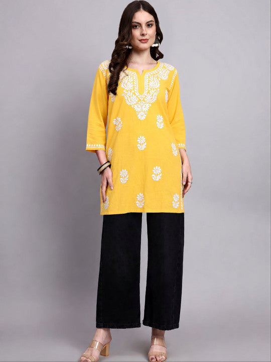 Trending Chikankari short kurta for women featuring floral embroidery, lightweight rayon fabric and a versatile design that pairs easily with jeans and trousers.